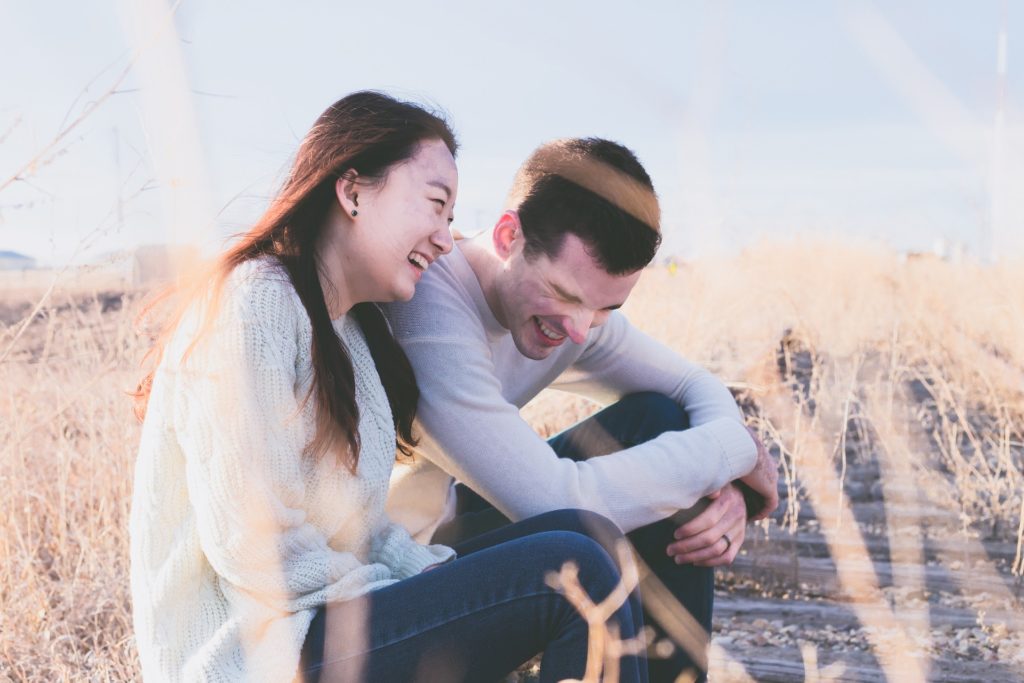 Photo of couple laughing.